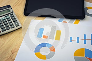 Financial graph with calculator and tablet