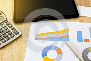 Financial graph with calculator and tablet