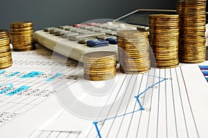 Financial growth and business success. Coins, calculator and charts.