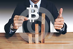 Financial growth concept, Businessman holding showing bitcoin symbol, concede Rise of price and the continued growth