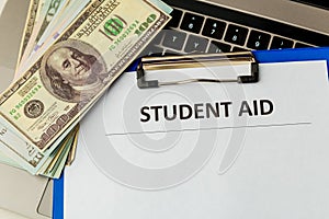Financial help for student statement. Money on the laptop.
