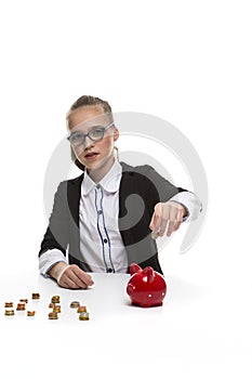 Financial Ideas and Concepts. Blond Teenager Girl Posing With Coins and Piggy Bank. Storing up Money With Moneybox For Savings