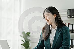 Financial institution worker female asian people, professionals engrossed in tasks. Business people diligently crunching numbers,