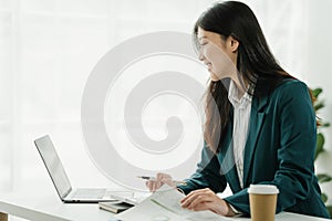 Financial institution worker female asian people, professionals engrossed in tasks. Business people diligently crunching numbers,