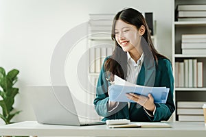 Financial institution worker female asian people, professionals engrossed in tasks. Business people diligently crunching numbers,