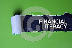 Financial Literacy Text written in torn paper