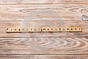 Financial Management word written on wood block. Financial Management text on wooden table for your desing, concept