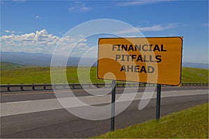 `Financial Pitfalls Ahead` Yellow Road Sign photo