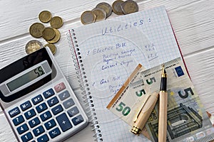 Financial planning with euro banknotes, notepad and calculator