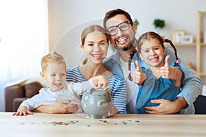 Financial planning   family mother father and children with piggy Bank at home