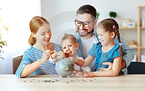 Financial planning   family mother father and children with piggy Bank at home