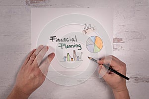 Financial planning sign with graphs and charts real hands holding pencil