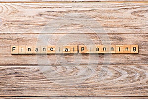 Financial planning word written on wood block. financial planning text on wooden table for your desing, concept