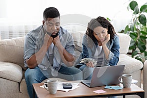 Financial Problems. Upset Black Couple Managing Family Budget Together At Home