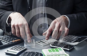 Financial professional or accounting at work with calculators