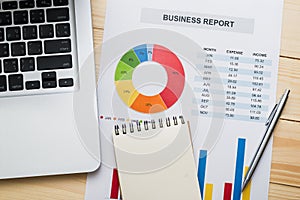 Financial report with laptop on wooden table. Accounting