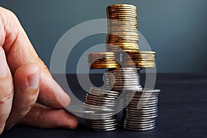 Financial Stability. Man holding coin in the coins stack.