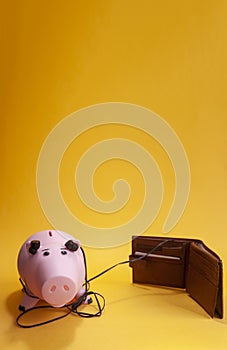 Financial success concept. listening to the money market, piggy bank with earphones listen a wallet