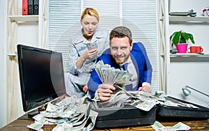 Financial success. Man businessman and woman secretary with pile dollar banknotes. Profit and richness concept