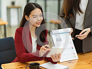 Financial team presents financial results on a spreadsheet and graph chart in the meeting