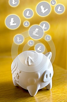 financial technology and internet money - piggy bank and coin sign of Litecoin LTC