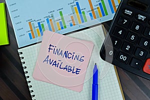 Financing Availabe write on sticky notes isolated on Wooden Table