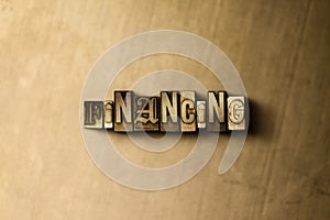 FINANCING - close-up of grungy vintage typeset word on metal backdrop