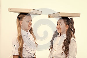 Find balance. Schoolgirls with cute pony tails hairstyle carry folders on heads. Perfect schoolgirls with tidy fancy