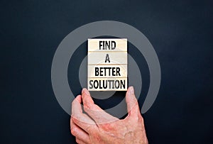 Find a better solution symbol. Concept words Find a better solution on wooden blocks. Beautiful black table black background.