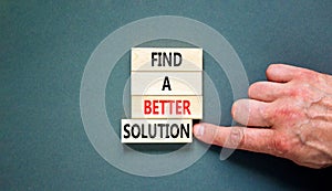 Find a better solution symbol. Concept words Find a better solution on wooden blocks. Beautiful grey table grey background.