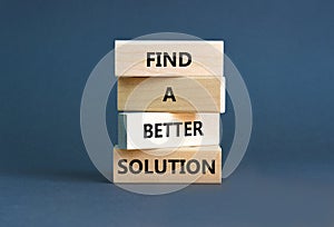 Find a better solution symbol. Concept words Find a better solution on wooden blocks. Beautiful grey table grey background.