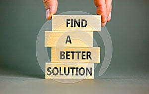 Find a better solution symbol. Concept words Find a better solution on wooden blocks. Beautiful grey table grey background.