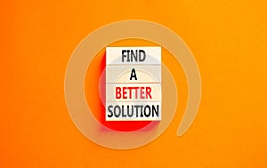 Find a better solution symbol. Concept words Find a better solution on wooden blocks. Beautiful orange table orange background.
