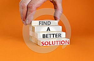 Find a better solution symbol. Concept words Find a better solution on wooden blocks. Beautiful orange table orange background.