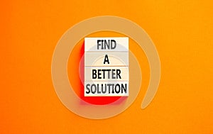 Find a better solution symbol. Concept words Find a better solution on wooden blocks. Beautiful orange table orange background.