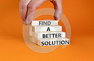 Find a better solution symbol. Concept words Find a better solution on wooden blocks. Beautiful orange table orange background.