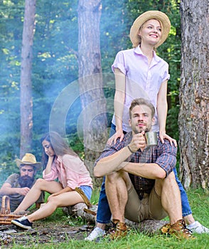 Find companion to travel and hike. Friends relaxing near campfire after day hiking nature background. Company friends