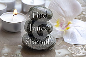 Find inner strength text engraved on black zen stones. Motivational concept.