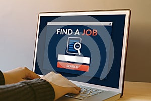 Find a job concept on laptop computer screen on wooden table
