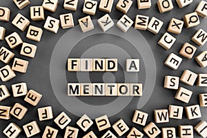 Find a mentor - phrase from wooden blocks with letters