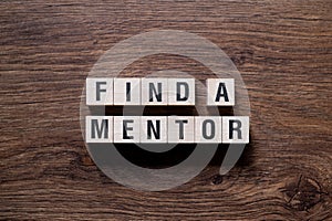 Find a mentor - word concept on building blocks, text