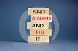 Find a need and fill it symbol. Concept words Find a need and fill it on wooden blocks on a beautiful grey table grey background.