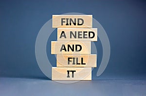 Find a need and fill it symbol. Concept words Find a need and fill it on wooden blocks on a beautiful grey table grey background.
