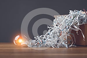 Find the new idea from past failures, Creative new design thinking for work, Light bulb and pile scrap paper from shredder on photo