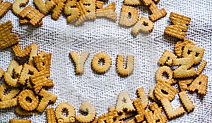 Find you Cookies in the form of the alphabet prospe words from homemade cookies on dark white background