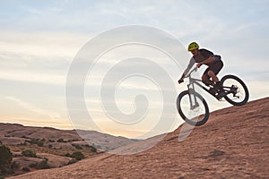 Find your own adventure and ride on. a young man out mountain biking during the day.