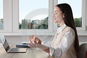 Find zen. Woman taking break from work at table in room