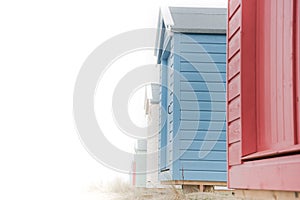 Findhorn, Scotland - July 2016: Colourful beach huts along the coast at Findhorn Bay in Northern Scotland among the sand dunes