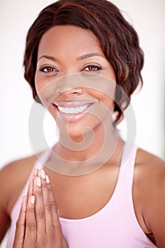 Finding her inner peace. A beautiful young african-american woman relaxing with a yoga routine.