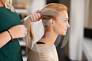 Finding the perfect look. Profile of a young woman getting her hair done.